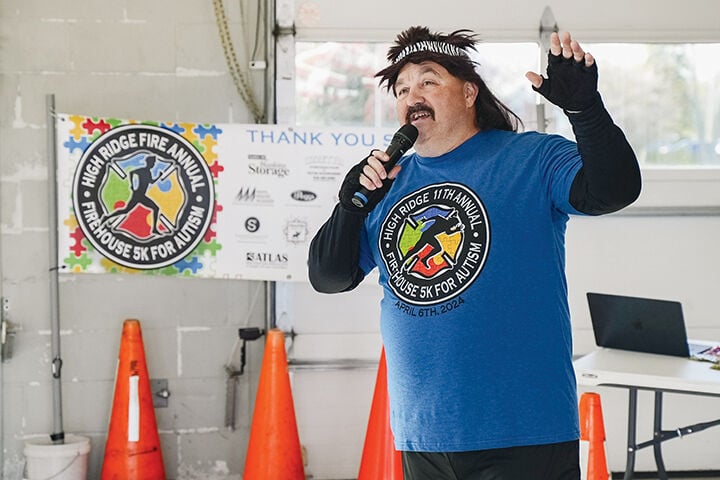 Former High Ridge Fire Marshal Ron Tisius speaks to a crowd as his rock star alter ego, “Sam Splint.”